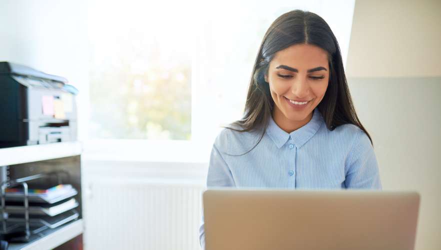 woman smiling at laptop