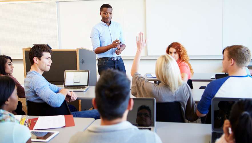 MALE TEACHER ELICITING A RESPONSE FROM HIS STUDENTS