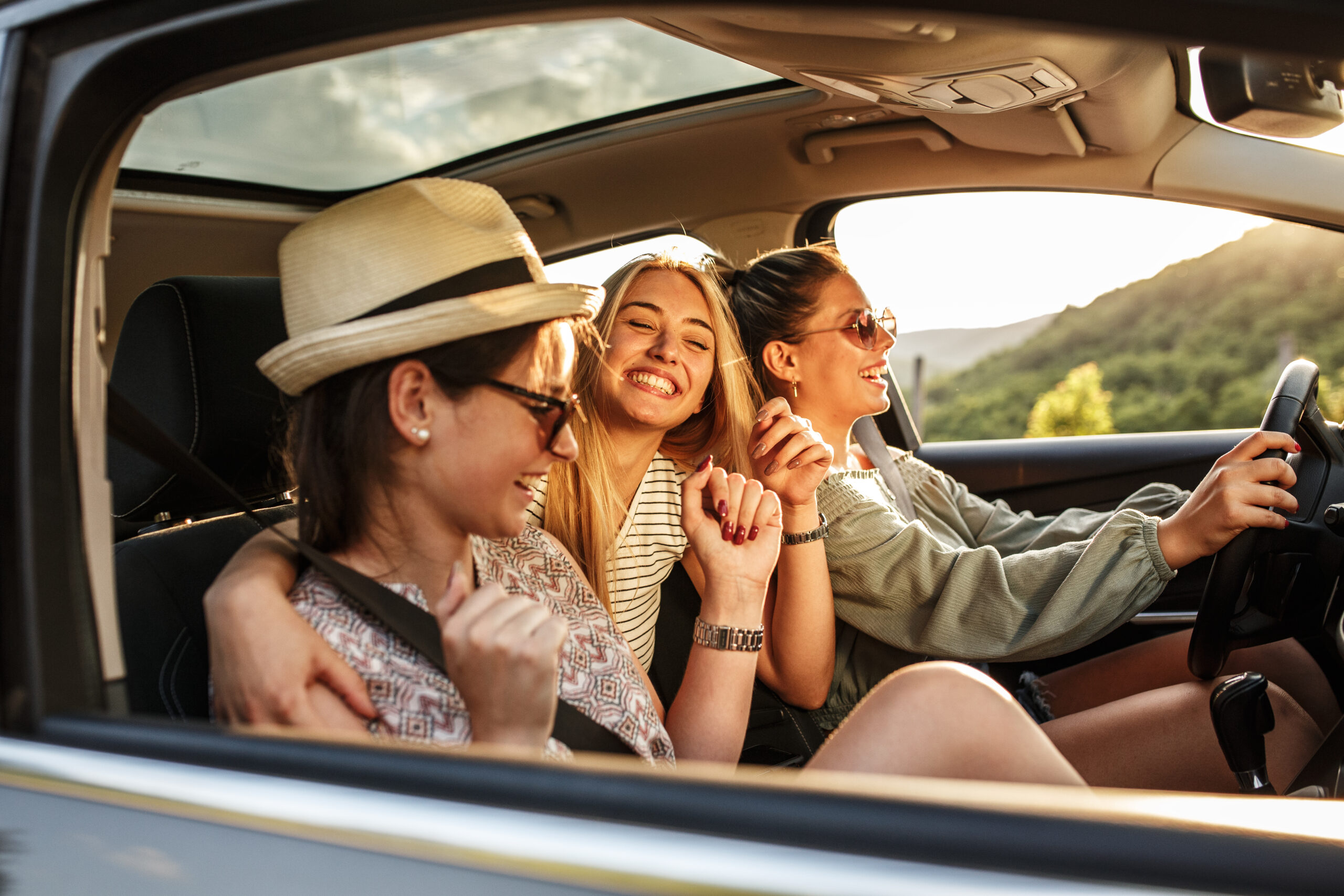 Group of best female friends travel together.They drives a car and having fun.Summer adventure.